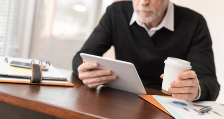 Businessman working on digital tablet at office