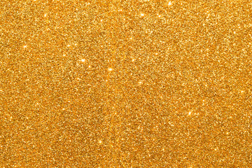 shine and sparkle of golden glitter abstract background	