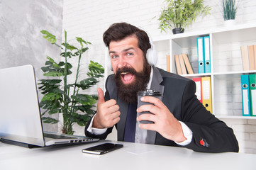 Stress resistance concept. Manager relaxing with favorite music and cup coffee. Regular morning in...