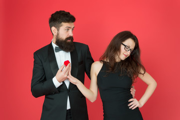 Couple in love celebrate anniversary. Proposal engagement. Romantic gift box jewelry engagement. Marriage proposal. Handsome man and elegant woman in love. Romantic engagement. Engagement concept