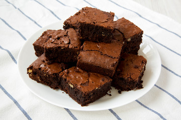 Homemade chocolate brownies on a white plate, low angle view. Close-up.
