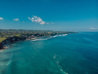 Aerial view of coastline with tropical beach and blue ocean in Bali