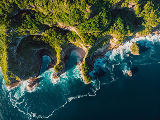 Amazing cliff, rocks and blue ocean with waves in Bali. Aerial view