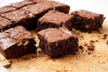 Freshly baked chocolate brownies on a baking sheet, side view. Close-up.