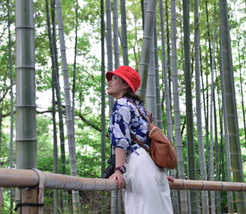 Asian young woman walking at forest