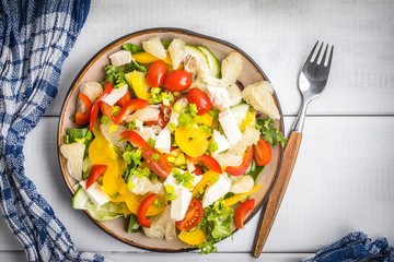 Salad with cheese and fresh vegetables.