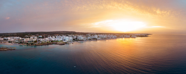 Fototapeta premium Aerial drone shot of Protaras city at sunset
