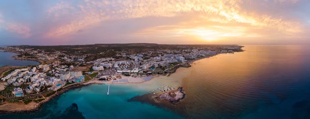 Tuinposter Cyprus Luchtfoto drone shot van Protaras stad bij zonsondergang