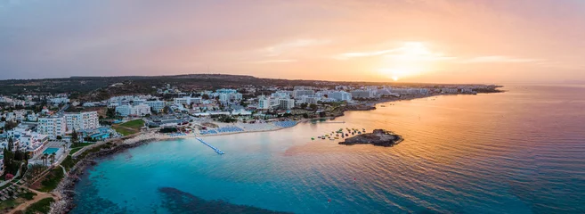 Poster Aerial drone shot of Protaras city at sunset © frimufilms