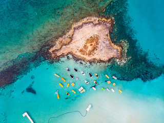 Island with boats parked near fig tree bay beach