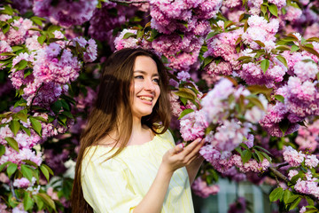 Fototapeta premium Soft and tender. Gorgeous flower and female beauty. Woman in spring flower bloom. Natural cosmetics for skin. Floral paradise. Floral shop. Girl in cherry blossom flower. Sakura tree blooming