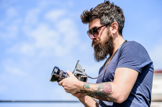 retro photographic equipment. hipster man in sunglasses. brutal photographer with camera. Mature hipster with beard. Bearded man. photo of nature. reporter or journalist. Enjoying his working day - Powered by Adobe