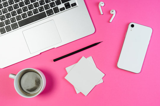 Laptop Phone Coffee Pink Business Workplace Top Flat Lay. White Smartphone, Airpod and Pencil on Minimal Clear Contemporary Background with Paper Note. Freelance Workspace Inspiration Concept