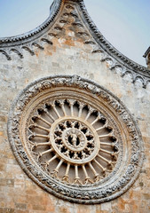 The traditional rosette and gothic architecture of the round socket over the main entrance to the...