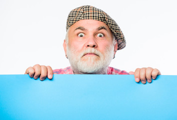 Senior bearded man place announcement on banner. scared mature man in retro hat. Advertisement....