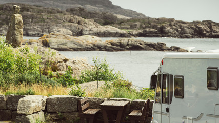 Camper car on coast of Norway with ocean view