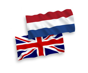 National vector fabric wave flags of Great Britain and Netherlands isolated on white background. 1 to 2 proportion.