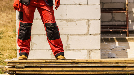 Person wearing red worker trousers