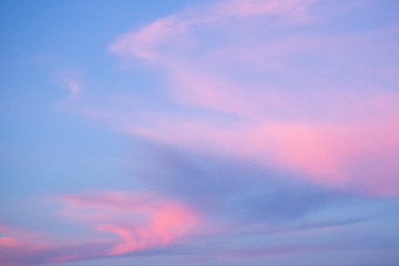 Blue sky and pink clouds. Sunset. Abstract background.