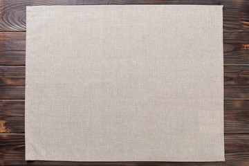 gray cloth napkin on rustic dark wooden background top view with copy space