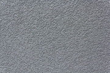 Grey rough plaster, concrete on wall closeup in sunny day, background, texture series