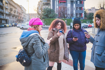 portrait of young women using smartphone in the street