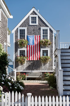 United States flag at suburban neighborhood. Provincetown, Cape Cod, Massachusetts, USA.