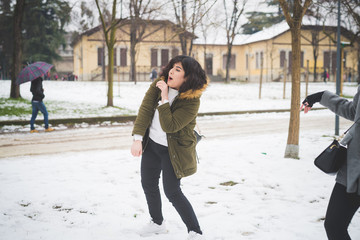 young brunette woman playing with friends in park