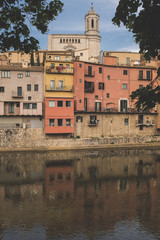 Fototapeta premium Girona's cityscape with famous river houses reflected in the rover landmark 
