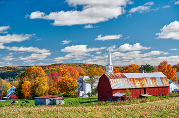 Congregational Church and farm with red barn at sunny autumn day in Peacham, Vermont, USA