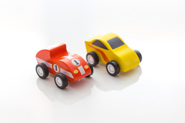 Fototapeta na wymiar Colourful toy wooden cars on a white background