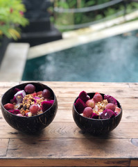 Served fruit salad wood  plate by hotel pool. Healthy food 