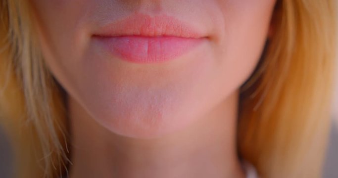 Closeup portrait of young sexy caucasian female face with cute lips with smiling expression