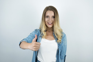 blond woman showing ok sign white background