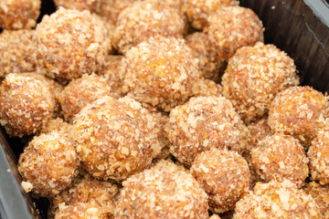 Candy in the form of balls of dried fruit with nuts. Eco sweets. Vegetarianism and raw food diet.