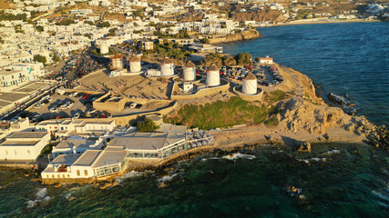 Aerial drone photo of iconic windmills overlooking the Aegean sea in main town of Mykonos island,...