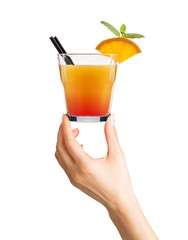 Woman hand holding cocktail glass with ice cubes on white background.