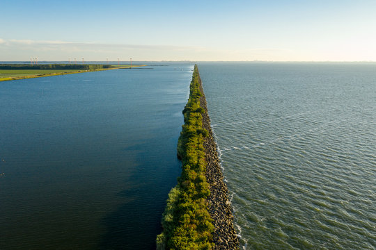 A wave breaking dike in a body of water.