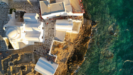 Aerial drone photo of popular landmark chapel of Paraportiani with beautiful emerald colour rocky...