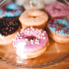 Sweet glazed donuts in cafe closeup.