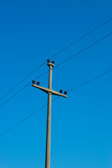 Concrete Wire Pole Against Blue Sky 