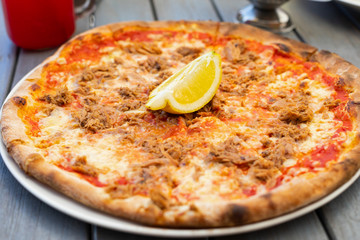 Pizza with tuna fish and lemon