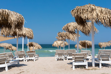 Colorful sunbeds and umbrellas at the beach
