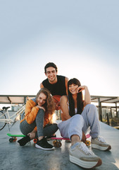 Group of friends hanging out at skate park