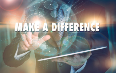 A hand selecting a Make A Difference business concept on a futuristic computer display.