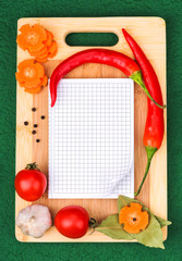Notebook with recipes and in the kitchen