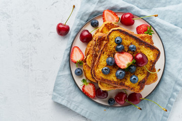 French toasts with berries, brioche breakfast, white background top view copy space