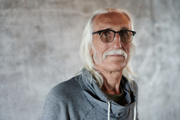 Portrait of aged gray haired Caucasian man pensioner in glasses. Cool grandpa with mustache and...
