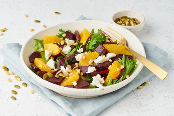 Vegan salad with beet curd avocado orange feta ricotta and pumpkin seeds, keto ketogenic dash diet, closeup, pastel modern background