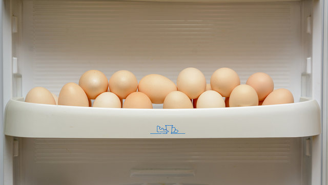 chicken eggs are in the door of the refrigerator tray